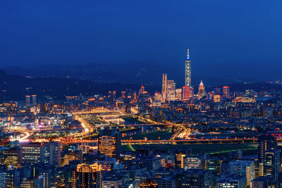 High angle view of city lit up at night