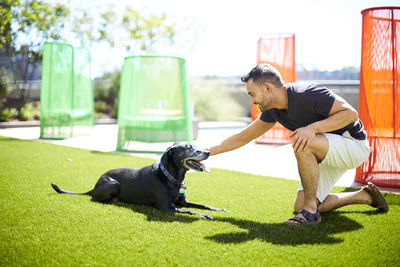 A man petting his dog.