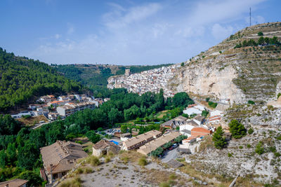 High angle view of buildings in town against sky