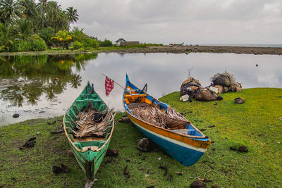 Boats moored in lake