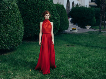 Portrait of woman standing on grass