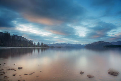 Amazing view of wanaka lake during evening with snowcapped mountains in background.new zealand.