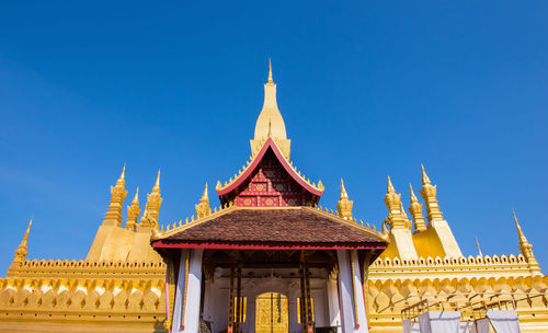 Low angle view of temple building against clear blue sky