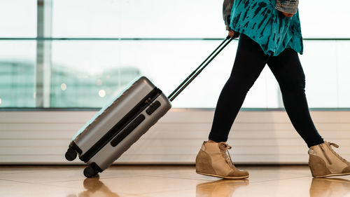 Low section of woman standing on hardwood floor