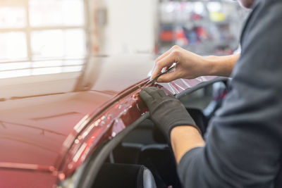 Midsection of man repairing car