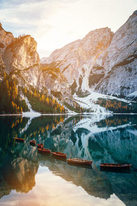 Scenic view of lake by snowcapped mountains against sky