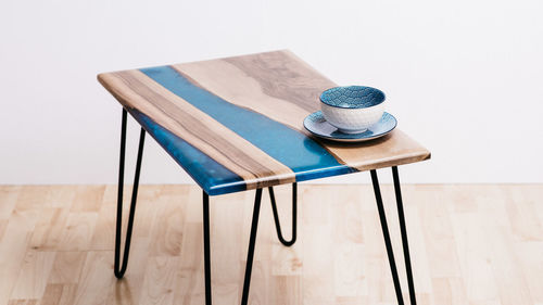 High angle view of chairs on table against white background