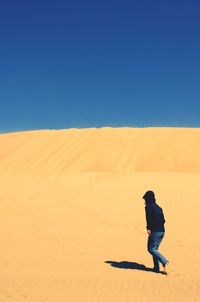 Full length of woman standing on arid landscape