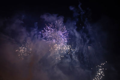 Low angle view of firework display at night