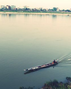 Boat sailing on river against sky