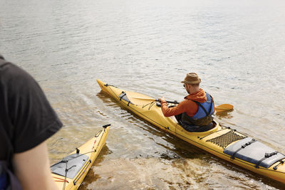 High angle view of man sitting in kayak on water