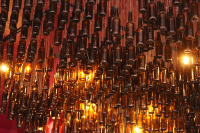 Full frame shot of illuminated candles in temple