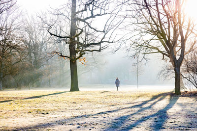 Man walking on field during winter