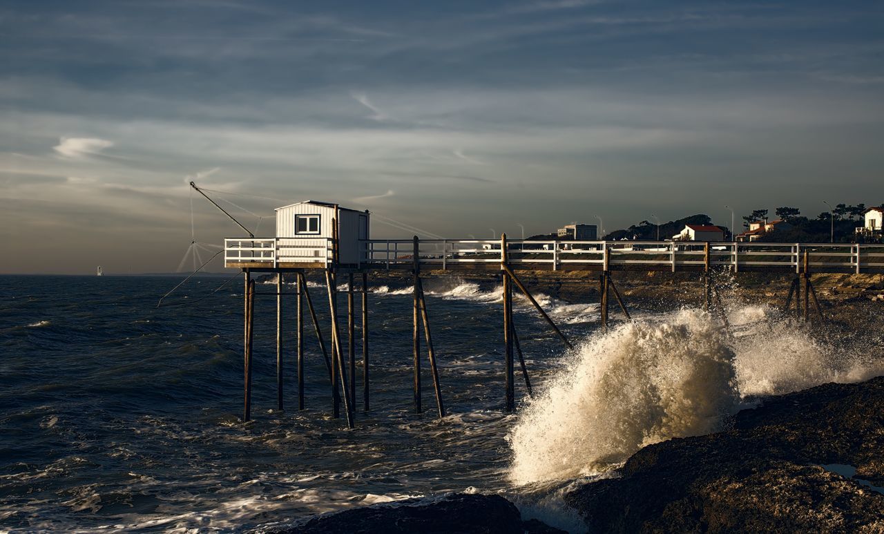 water, sea, sky, bird, built structure, cloud - sky, beach, horizon over water, architecture, wave, shore, animal themes, scenics, nature, seagull, pier, cloudy, beauty in nature, cloud, animals in the wild