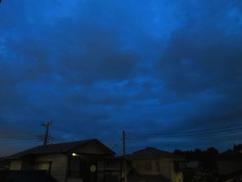 Low angle view of silhouette buildings against sky at dusk