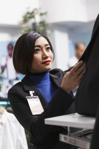 Portrait of young businesswoman using mobile phone