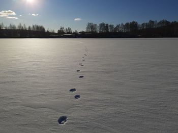 Scenic view of snow covered land against sky