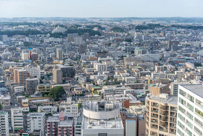 High angle view of buildings in city against sky