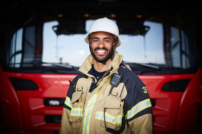 Portrait of a smiling man standing in car