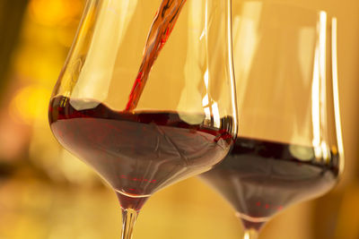 Glasses with red wine in a festive room for a celebration - selective focus