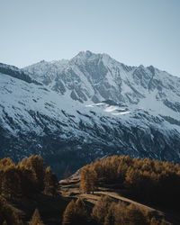 Scenic view of snowcapped mountains against clear sky