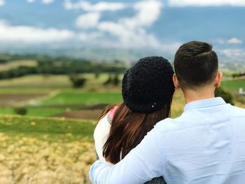 Rear view of couple on field