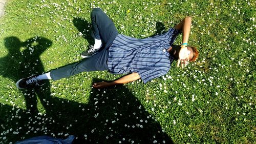 Low section of man lying on grass