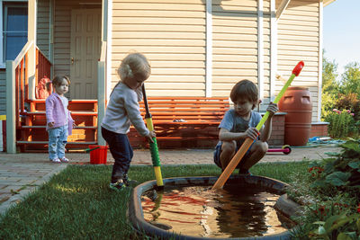 Rear view of people and daughter in water