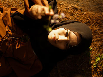 High angle portrait of man lying down on land