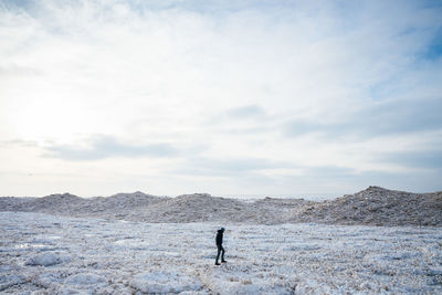 Man standing on field against sky