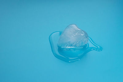 Close-up of drink in water against blue background