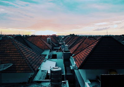 High angle view of townscape against cloudy sky during sunset
