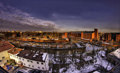 Cityscape against cloudy sky during winter