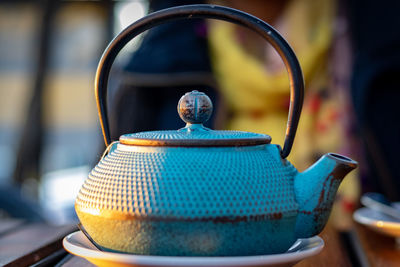 Close-up of metallic tea kettle on table