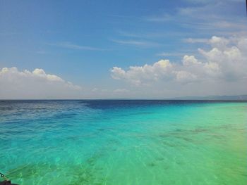 Scenic view of sea against cloudy sky