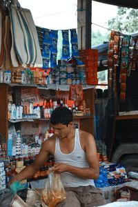 Midsection of man at market stall