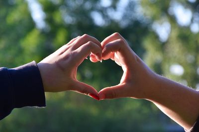 Close-up of hands holding heart shape