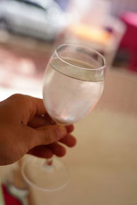 Close-up of hand holding wineglass