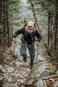 A retirement age male hiker with a pack walks the appalachian trail