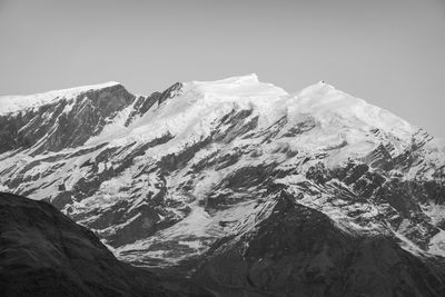 Scenic view of snowcapped mountains against clear sky