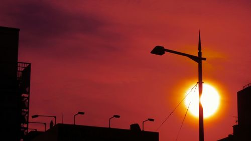 Low angle view of street light against sky at sunset