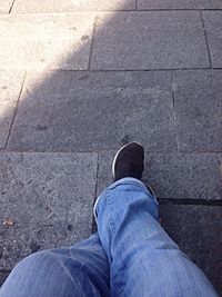 Low section of woman standing on tiled floor