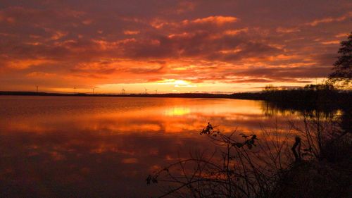 Scenic view of lake against romantic sky at sunset