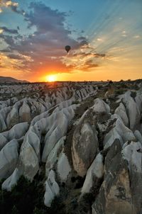 Scenic view of rocks against sky during sunset