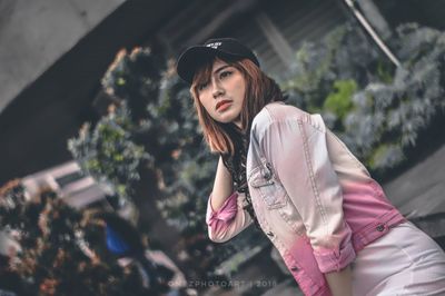 Portrait of beautiful young woman wearing hat