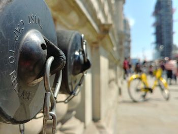 Close-up of bicycle on bridge in city