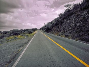 Surface level of empty road against sky