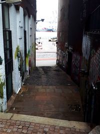 Empty alley amidst buildings in city