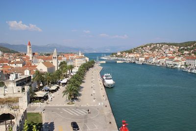 High angle view of townscape by sea against sky