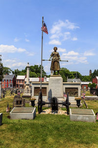 Statue of cemetery against sky